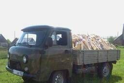 Firewood birch chopped. UAZ dump truck.