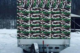 Camouflage awning on a light trailer