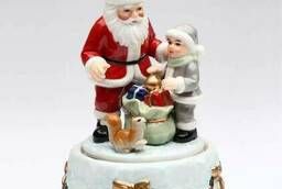 Santa Claus gives gifts. Musical porcelain figurine. ...